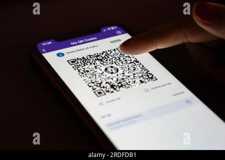 In this photo illustration, the PhonePe QR code, is seen displayed on mobile phones screen in Guwanati, India on 19 July 2023. Stock Photo