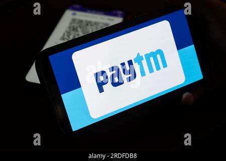 In this photo illustration, the Paytm logo and PhonePe QR code, is seen displayed on mobile phones screen in Guwanati, India on 19 July 2023. Stock Photo