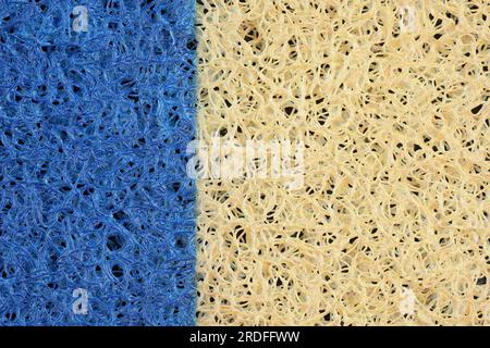 Bright yellow and blue Door mat on PVC basis. Anti-slip mats and coverings top view. Special surface for cleaning dirt from shoe soles. Background of Stock Photo