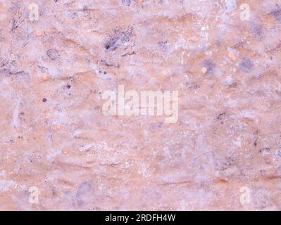 Grunge painted surface of wall. Pink urban cement wall, stucco. Grunge architecture backdrop. Uneven solid surface. Drawing texture. Stock Photo