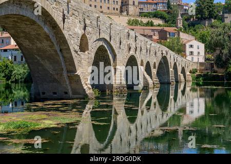 The most recognisable tourist attraction of Beziers is Pont Vieux - old bridge. The pedestrian bridge looks picture perfect with the river Orb below. Stock Photo