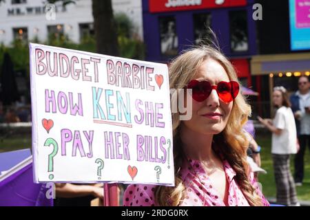 A demonstrator holds a placard as she takes part in a protest by members of the British actors union Equity in Leicester Square, London, in solidarity with striking Hollywood members of the Screen Actors Guild - American Federation of Television and Radio Artists (Sag-Aftra). Picture date: Friday July 21, 2023. Stock Photo