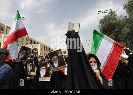 Tehran, Iran. 21st July, 2023. An Iranian demonstrator holds up a copy of Quran, Islam's holy book, during a protest of the burning of a Quran in Sweden, in Tehran, Iran, Friday, July 21, 2023. On Thursday, a man who identified himself in Swedish media as a refugee from Iraq burned a Quran for the second time in central Stockholm. (Photo by Sobhan Farajvan/Pacific Press) Credit: Pacific Press Media Production Corp./Ģ����ý Live News Stock Photo