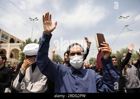 Tehran, Iran. 21st July, 2023. An Iranian demonstrator holds up a copy of Quran, Islam's holy book, during a protest of the burning of a Quran in Sweden, in Tehran, Iran, Friday, July 21, 2023. On Thursday, a man who identified himself in Swedish media as a refugee from Iraq burned a Quran for the second time in central Stockholm. (Photo by Sobhan Farajvan/Pacific Press) Credit: Pacific Press Media Production Corp./Ģ����ý Live News Stock Photo