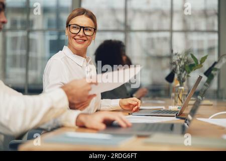 Business team is analysing new financial project while working together on office desk Stock Photo