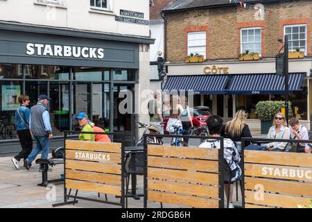 People sitting outside Starbucks coffee shop having drinks in Henley-on-Thames town centre, Oxfordshire, England, UK Stock Photo