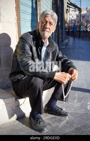 Man angel holding prayer beads in mand hands, Amman, Jordan Stock Photo