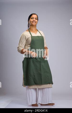 Indian women chef, potrait of a lady wearing apron with white background, isolated Stock Photo