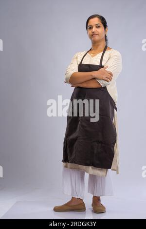 Indian women chef, potrait of a lady wearing apron with white background, isolated Stock Photo