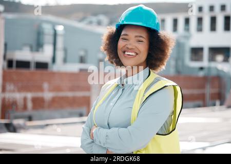Portrait, engineer and woman with arms crossed in city for career in renewable energy on rooftop. Face, architect and confident developer, solar Stock Photo