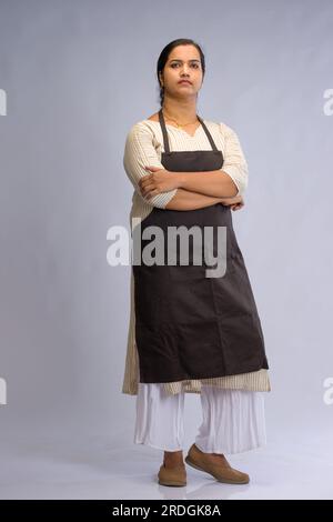 Indian women chef, potrait of a lady wearing apron with white background, isolated Stock Photo