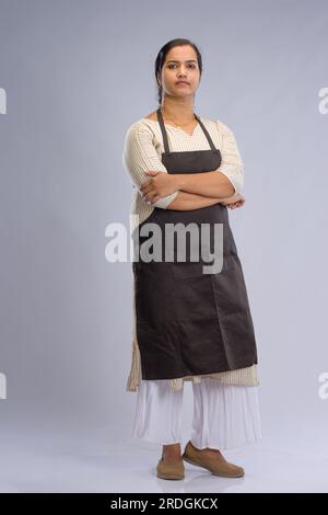 Indian women chef, potrait of a lady wearing apron with white background, isolated Stock Photo