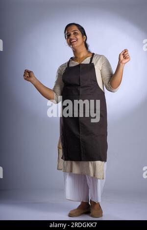 Indian women chef, potrait of a lady wearing apron with white background, isolated Stock Photo