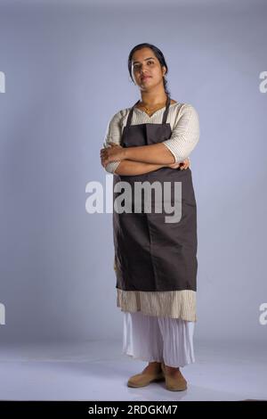 Indian women chef, potrait of a lady wearing apron with white background, isolated Stock Photo