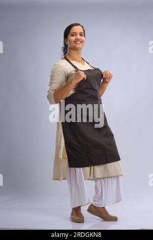 Indian women chef, potrait of a lady wearing apron with white background, isolated Stock Photo