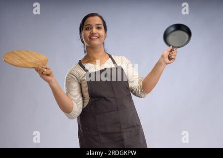 Indian women chef, potrait of a lady wearing apron with white background, isolated Stock Photo