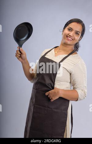 Indian women chef, potrait of a lady wearing apron with white background, isolated Stock Photo