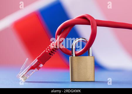 Closed padlock on a knotted network wire against the background of the Russian flag, a concept on the topic of the security of Internet technologies i Stock Photo