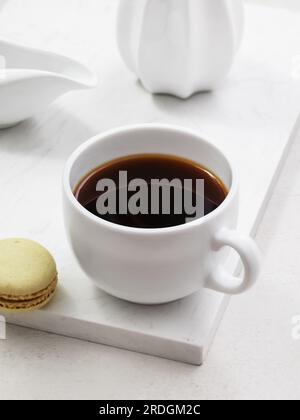 Cup of coffee with macaroons on the table Stock Photo