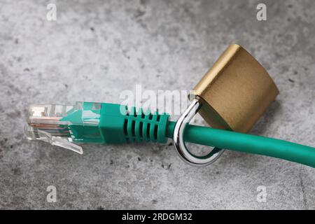 Closed lock on a network wire, a concept on the topic of network connection security Stock Photo