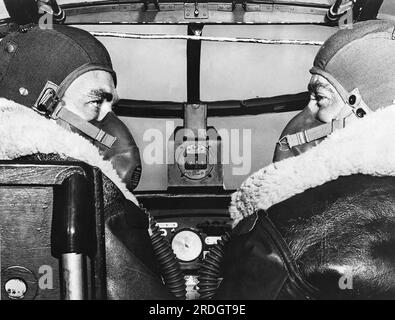 Fort Worth, Texas:  June, 1944 Two aviation cadets from Brooks Field wearing oxygen masks and winter flying suits as they pilot a B-25 bomber on a routine high altitude training mission. Stock Photo