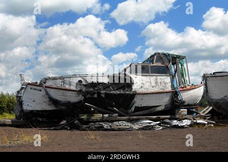 Lake Superior fishing boat sits retired from service near Ripley, Michigan, in the Upper Peninsula.  The boat has cracked and peeling paint, broken wi Stock Photo