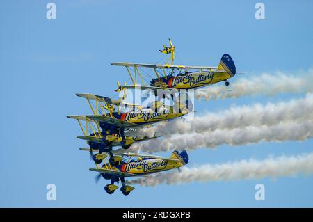 Aerosuperbatics Utterly Butterly wingwalkers display team flying in formation at Southend Airshow. Boeing Stearman biplanes with wing walkers. Females Stock Photo