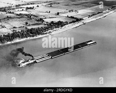 United States   June 14, 1940 An aerial view of a sternwheeler river boat pushing empty barges up the Ohio River. The photograph was taken from an American Airlines plane. Stock Photo