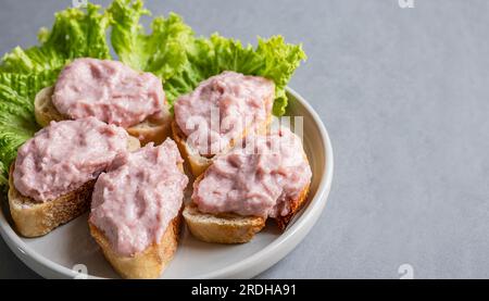 Toasts with tarama or taramasalata canape on a plate with salad Stock Photo