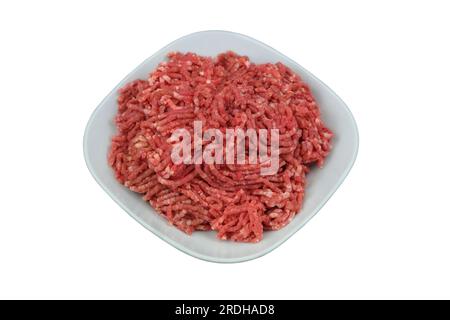 Bowl of mince isolated on white background. Homemade minced meat comes out of the meat grinder. Cooking a burger. Stock Photo