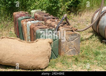 Old rusty WWII petrol cans outdoors Stock Photo