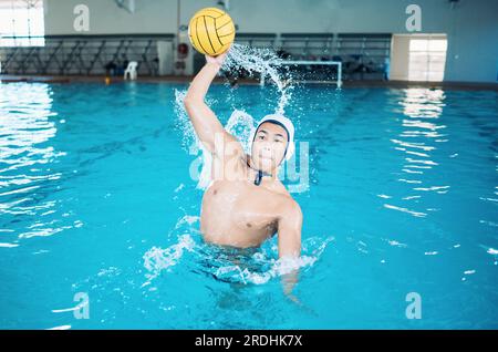 Sports, fitness and water polo with man in swimming pool for exercise, training and games. Championship, workout and performance with person and ball Stock Photo