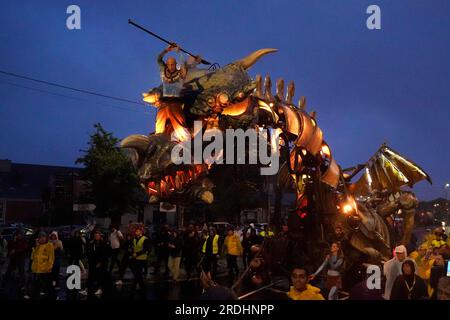 People watch a 30ft mechanical creature performing in Dragon - The Forgotten World by Planete Vapeur at Eyre Square as part of the Galway International Arts Festival. Picture date: Friday July 21, 2023. Stock Photo