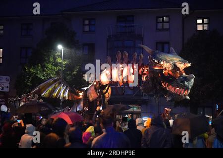 People watch a 30ft mechanical creature performing in Dragon - The Forgotten World by Planete Vapeur at Eyre Square as part of the Galway International Arts Festival. Picture date: Friday July 21, 2023. Stock Photo