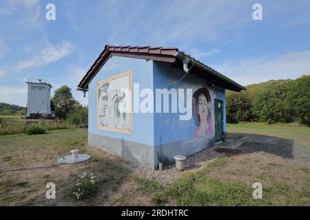 Inner German border of the former GDR with observation tower and house with graffiti and slogan for freedom, Vacha, Thuringia, Germany Stock Photo