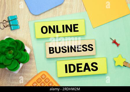 On the desk with handwriting of Online Business Idea word in notebook. Stock Photo