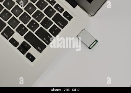 Closeup of USB stick connected to laptop, illustrating the importance of digital memory in the digital age. Stock Photo