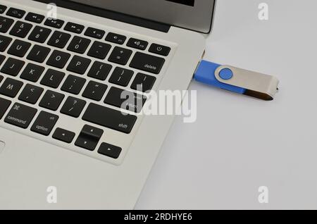 Closeup of the pendrive on the laptop, portraying the practicality and mobility provided by the technology. Stock Photo