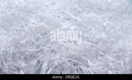 Background of white shredded paper. Paper strips. Stock Photo