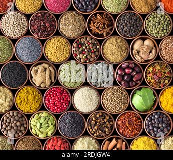various condiments in cups, food background. Spice texture isolated on black Stock Photo