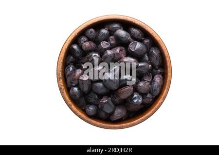 barberry dried black seasoning in a wooden bowl, top view. spice isolated on white Stock Photo