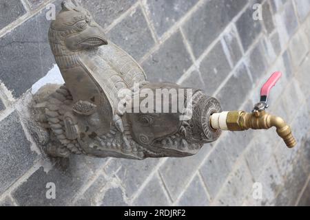 Water tap with antique style of connectivity, connectors with stone carving, drinking water tap made up of natural grey stone Stock Photo