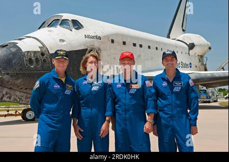 Space shuttle Atlantis crew members (from left) commander Chris Ferguson of Philadelphia, Pa., mission specialist Sandy Magnus of Belleville, Ill., pilot Doug Hurley of Endicott, N.Y., and mission specialist Rex Walheim of Redwood City, Calif., posed for a group photo in front of the orbiter after completing mission STS-135 on Thursday, July 21, 2011 at NASA's Kennedy Space Center in Cape Canaveral, Fla. STS-135 was the final mission for both the Atlantis orbiter and the 30-year-old space shuttle program. (Apex MediaWire Photo by Kim Shiflett/NASA) Stock Photo