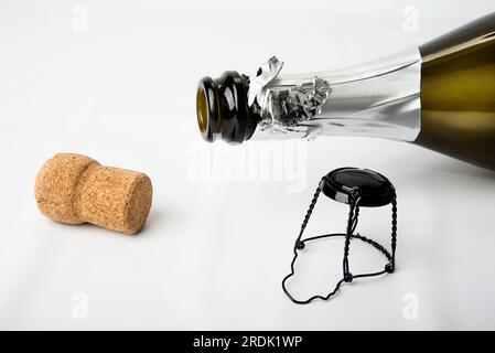 Cork and empty champagne bottle on white Stock Photo