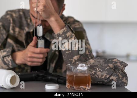 Portrait of middle aged sad, desperate military man. Disabled soldier suffering from depression psychological trauma. PTSD concept. Stock Photo