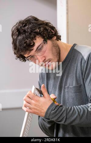 Apprentices working in various building trades including carpentry, brick laying, joinery, tiling , plastering, masonry and decorating Stock Photo