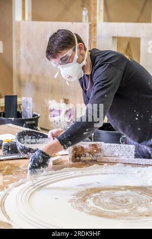 Apprentices working in various building trades including carpentry, brick laying, joinery, tiling , plastering, masonry and decorating Stock Photo