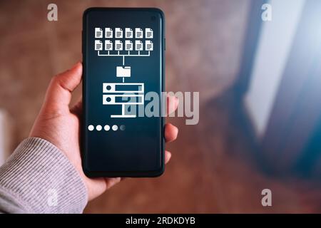 Woman hand showing data host server storage on smartphone screen. Icon for information exchange and transfer concept. Stock Photo