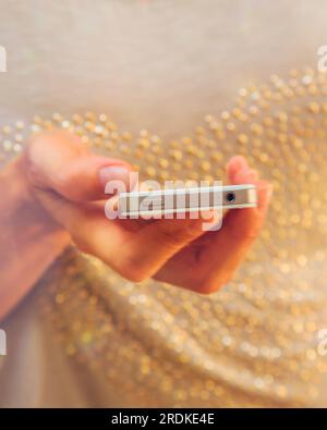 Woman's hand holding smart phone. Stock Photo