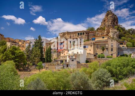 Village of Foradada in a spring noon with the characteristic rock that culminates the village (La Noguera, Lleida, Catalonia, Spain) Stock Photo